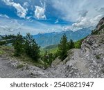 Scenic hiking trail from Valbona to Theth overlooking majestic mountain ranges of Albanian Alps (Accursed Mountains) in Northern Albania. Wanderlust in alpine wilderness. valley covered in greenery