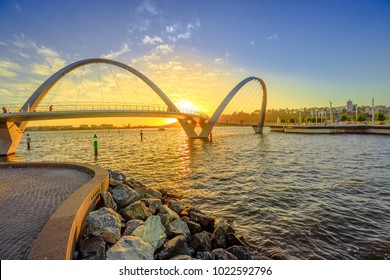 Scenic and iconic Elizabeth Quay Bridge at sunset light on Swan River at entrance of Elizabeth Quay marina. The arched pedestrian bridge is a new tourist attraction in Perth, Western Australia.