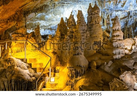 A scenic and illuminated view of the caverns inside Lewis and Clark Caverns State Park is captured, highlighting the stunning geological formations and the unique lighting that enhances their beauty