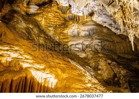 A scenic and illuminated view of the caverns inside Lewis and Clark Caverns State Park is captured, highlighting the stunning geological formations and the unique lighting that enhances their beauty