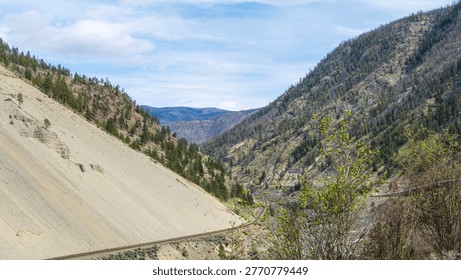 A scenic journey through BC's dramatic transition - from rushing glacial waters of Kicking Horse Canyon to the dry, rugged landscapes of the Thompson river near Kamloops where rail, river, and highway wind together through vast canyon terrain.