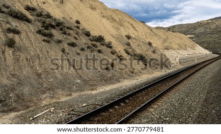 A scenic journey through BC's dramatic transition - from rushing glacial waters of Kicking Horse Canyon to the dry, rugged landscapes of the Thompson river near Kamloops where rail, river, and highway wind together through vast canyon terrain.