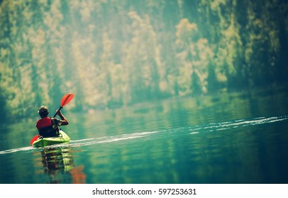 Scenic Kayak Lake Tour. Senior Kayaker On The Lake.