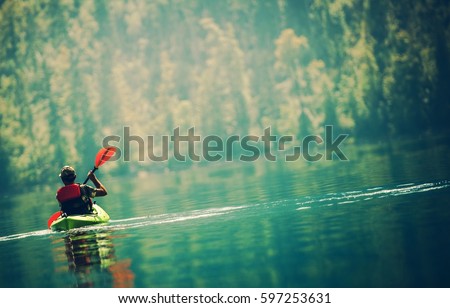 Scenic Kayak Lake Tour. Senior Kayaker on the Lake.