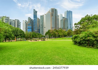 Scenic Kuala Lumpur skyline. Amazing view of a green city park in Kuala Lumpur, Malaysia. High-rise buildings are visible on blue sky background. Kuala Lumpur is a popular tourist destination of Asia. - Powered by Shutterstock