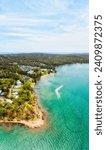 Scenic lagoon lakeshore aerial vertical panorama of Lake Macquarie at Murrays beach in Australia.