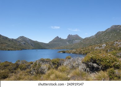 Scenic landscape image of Cradle Mountain National Park in Tasmania, Australia, with clear water of Dove Lake, blue sky as copy space.