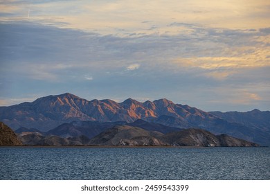 Scenic landscape with rugged arid mountains on the horizon during sunset in Bahia de los Angeles, Baja California, Mexico - Powered by Shutterstock