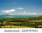 Scenic landscape view of Mission Beach,Queensland, Australia, with a view to offshore islands over lush green fields