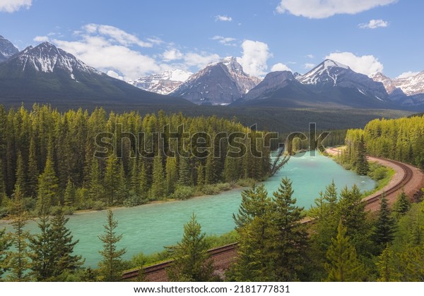 Scenic landscape view of\
railway train tracks and the Bow River at Morant\'s Curve viewpoint\
in Banff National Park in the Rocky Mountains of Alberta,\
Canada