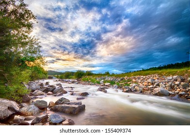Scenic landscape view of a slow flow long exposure of South Boulder Creek at sunset in Rollinsville Colorado.  