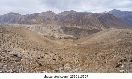 Scenic landscape view of Wakhan mountain range in Afghanistan and Pamir river valley from high-altitude desert, Ishkashim, Gorno-Badakhshan, Tajikistan - Powered by Shutterstock