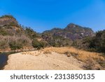 Scenic landscape of Wuyi Mountains peaks and the River of Nine Bends, Fujian province, China. River, rock formations, blue sky with copy space
