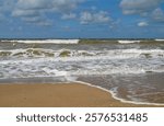 scenic maritime view of the North See with its foamy waves and fine-sand beaches of the Belgian city Ostend (Oostende, Belgium)                           