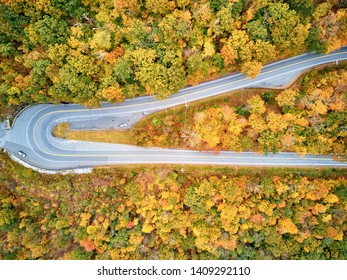 Scenic Mohawk Trail highway hairpin turn in autumn, Massachusetts, USA. Fall in New England. Aerial drone shot. 