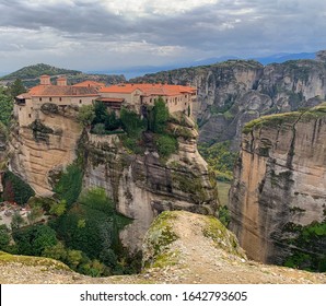 Scenic Monestary Upon Steep Rocky Cliffs In The Mountains Of Meteora, Greece.