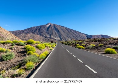 Scenic mountain road leading to volcano Pico del Teide, Mount El Teide National Park, Tenerife, Canary Islands, Spain, Europe. Volcanic dry landscape. Road trip on a sunny summer day. Freedom vibes - Shutterstock ID 2179957439