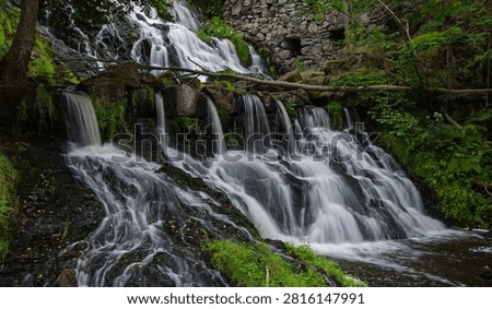 Scenic Multi Tier Waterfall Cascade Beside Historic Stone Mill Ruins in Lush Forest