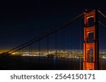 A scenic night shot of the Golden Gate bridge with decorative lights and skyline in the background