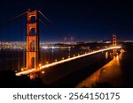 A scenic night shot of the Golden Gate bridge with decorative lights and skyline in the background