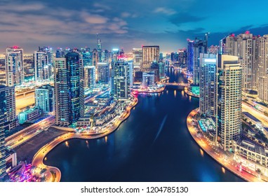Scenic nighttime skyline of big modern city with illuminated skyscrapers. Aerial view of Dubai Marina, UAE. 