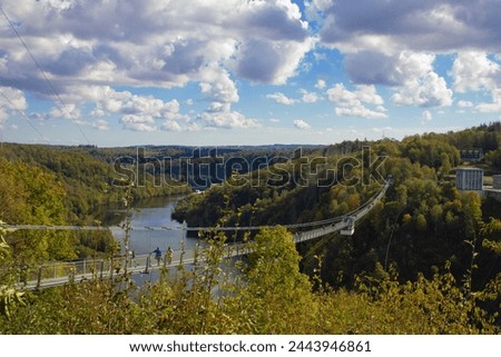 Scenic Overlook of a Suspension Bridge Spanning a Serene River Valley During Autumn. Titan RT, Harz, Germany