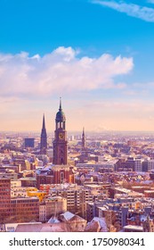 Scenic Panorama View From Dancing Towers Over Hamburg Under Snow In Winter With St. Michael's Church (German: St. Michaelis) And Downtown City Skyline At Sunset.