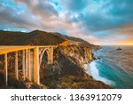 Scenic panoramic view of historic Bixby Creek Bridge along world famous Highway 1 in beautiful golden evening light at sunset with dramatic cloudscape in summer, Monterey County, California, USA