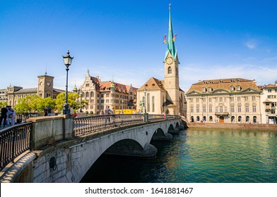Scenic panoramic view of historical old city center of Zurich with famous Fraumunster Church and Munsterbrucke crossing river Limmat on a beautiful sunny summer day, Canton of Zurich, Switzerland