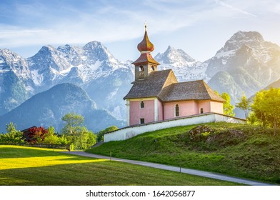 Scenic panoramic view of idyllic Auer Kircherl, an old historical chapel in the alps near the famous old village of Lofer, in beautiful golden evening light at sunset in summer, Salzburg Land, Austria