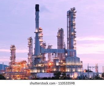 scenic of petrochemical oil refinery plant shines at night, closeup