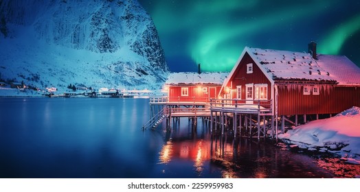 Scenic photo of winter fishing village with northern lights. stunning natural background. Picturesque Scenery of Reinefjord one most popular place of Lofoten islands. Norway. ideal resting place. - Powered by Shutterstock