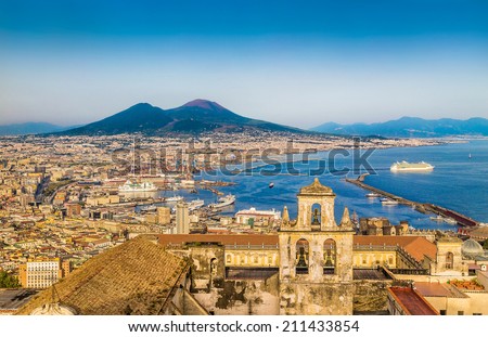 Scenic picture-postcard view of the city of Napoli (Naples) with famous Mount Vesuvius in the background in golden evening light at sunset, Campania, Italy