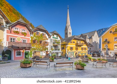 Scenic picture-postcard view of the historic town square of Hallstatt with traditional colorful houses and church at Hallstatter See in the Austrian Alps in fall, region of Salzkammergut, Austria