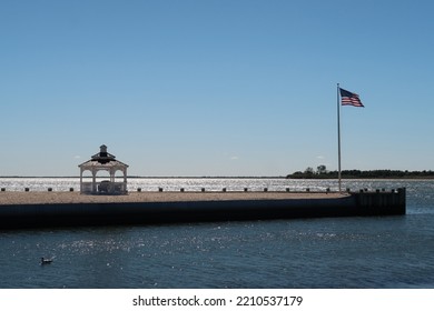 Scenic Pier With A Pretty Gazebo And An American Flag. 