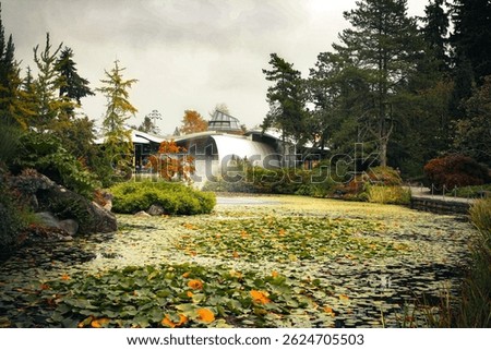 A scenic pond with a central fountain and autumnal trees reflected in still water, capturing a peaceful moment.