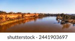 Scenic red cliffs of clay on shores of Murray river at Mildura town on Victoria - NSW border of Australia - aerial panorama.