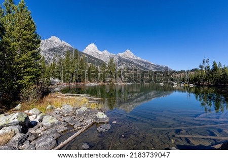 Scenic Reflection of the Tetons in Taggart Lake in Auutmn