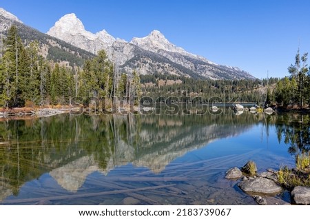 Scenic Reflection of the Tetons in Taggart Lake in Auutmn