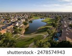 A scenic residential area with green trees and a lake. Arrowhead Ranch, Glendale, Arizona, USA