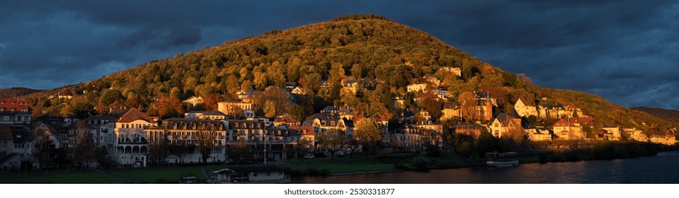 Scenic residential area on a hill in Heidelberg, Germany, illuminated by the warm intense sunset light, with dark clouds - Powered by Shutterstock