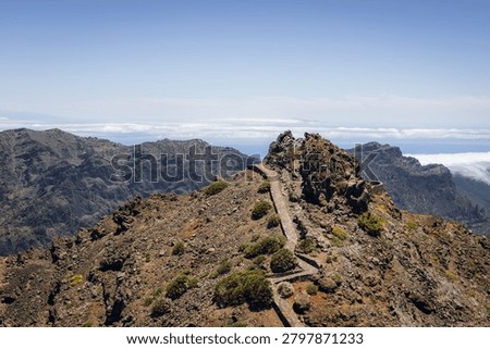 Scenic ridge path and cloud waterfall at Roque de los Muchachos, La Palma