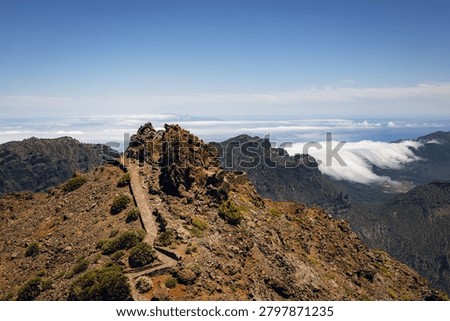 Scenic ridge path and cloud waterfall at Roque de los Muchachos, La Palma