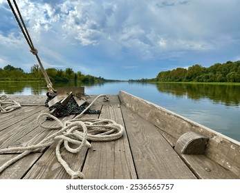 Scenic River Cruise on a Traditional Wooden Boat with Ropes and Calm Views of the Loire’s Natural Shores - Powered by Shutterstock