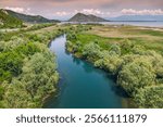 Scenic river winding through the greenery of Skadar National Park, a paradise for nature enthusiasts