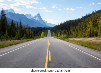 Scenic Road In The Canadian Rockies During A Vibrant Sunny Summer Day. Taken In Icefields Parkway, Banff National Park, Alberta, Canada.