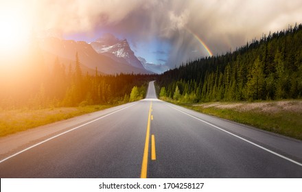 Scenic road in the Canadian Rockies during a vibrant sunny summer day with Rainbow. Rainy Sky Composite. Taken in Icefields Parkway, Banff National Park, Alberta, Canada. - Powered by Shutterstock