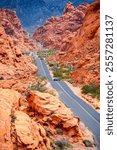 Scenic road in the famous “Valley of Fire“ State Park, a public recreation and nature preservation area in the Mojave Desert, near Las Vegas (Nevada, USA). Unique landscape with red sandstone rocks.