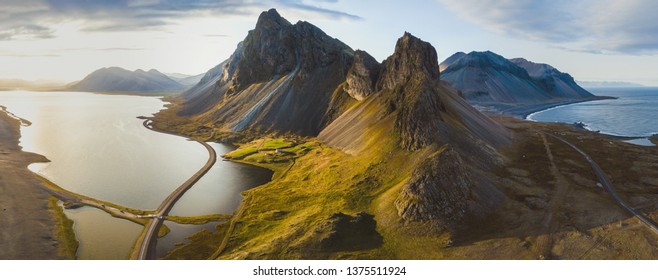 scenic road in Iceland, beautiful nature landscape aerial panorama, mountains and coast at sunset