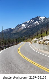 Scenic Road Surrounded By Trees And Mountains On A Sunny Day. Summer Season. Lake Tahoe, California, United States. Adventure Travel.